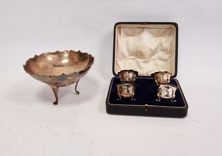 Silver bowl raised on three feet, London assay office mark and four boxed silver salts raised on