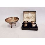 Silver bowl raised on three feet, London assay office mark and four boxed silver salts raised on