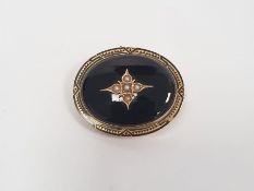 Victorian gold mourning brooch set with black onyx and seed pearls in a gold mount, engraved to