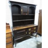 20th century oak dresser in the Georgian manner, the moulded cornice above cupboard door and open