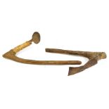 Two African digging tools, wooden handled with iron heads, one head tied the other fitted.