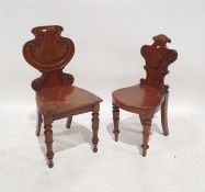 Two mahogany hall chairs with carved shaped seats and turned front legs (2)