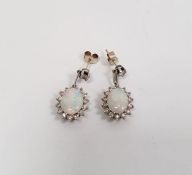 Pair of 18k white gold, diamond and opal drop stud earrings  Condition Report1 opal with cracks.  We