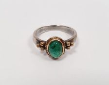 White metal ring set cabochon emerald in gold-coloured ropetwist setting