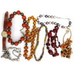 One tray of assorted costume jewellery to include amber bead necklace, further necklace, clip-on