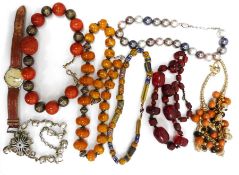 One tray of assorted costume jewellery to include amber bead necklace, further necklace, clip-on