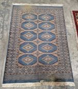 Modern Eastern wool rug with five rows of two octagonal guls in grey-green and beige geometric