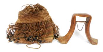 Ugandan carved wood headrest/pillow and a woven bag decorated with dried seed pods.Condition