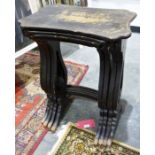 Quartetto nest of four 1920's lacquered tables, the shaped tops with gold-coloured Eastern scenes,