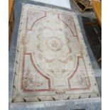 Large cream ground aubusson style rug with central floral pattern and octagonal geometric borders