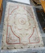 Large cream ground aubusson style rug with central floral pattern and octagonal geometric borders