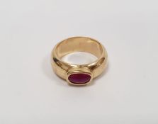 18ct gold and ruby gent's dress ring, the barrel-shaped band set oval cabochon stone, in rubover