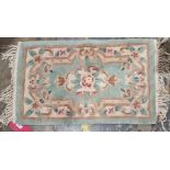 Four Chinese superwash rugs to include a pink ground rug with floral medallion with floral border