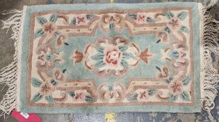 Four Chinese superwash rugs to include a pink ground rug with floral medallion with floral border