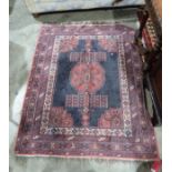 Eastern style red ground rug with central geometric medallion and multiple geometric borders