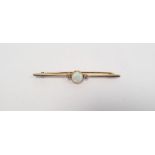 Yellow gold bar brooch set with a fire opal and two diamonds, not hallmarked