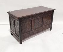 Early 20th century oak coffer, the rectangular top with carved and moulded edge, three carved panels