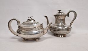 Georgian silver teapot and hot water pot, each with foliate finial handles, bone insulator to the