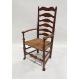 Oak ladderback rush-seated chair on turned legs to pad feet, turned stretcher