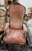 19th century armchair with pink upholstered seat, back and arm rest, overscrolled hand rests, on