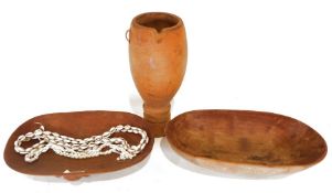 Two African carved wood bowls, one featuring carved elephants to either side, along with two