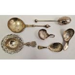 Three Georgian silver tea caddy spoons each with shell bowls, a Victorian egg-shaped tea infuser