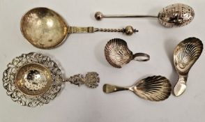 Three Georgian silver tea caddy spoons each with shell bowls, a Victorian egg-shaped tea infuser