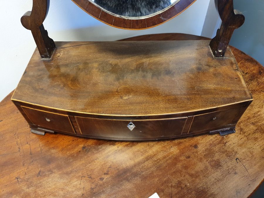 19th century mahogany shield-shaped dressing mirror with three drawers to the bowfront base, on ogee - Image 11 of 20