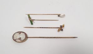 Carved shell cameo-topped stickpin and three various stickpins set with seedpearls, blue stones,
