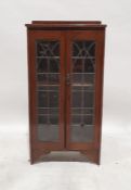 20th century oak bookcase with leaded glazed doors enclosing shelves, on bracket feet, 124cm x