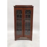 20th century oak bookcase with leaded glazed doors enclosing shelves, on bracket feet, 124cm x