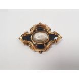Victorian gold and black enamel memorial brooch, lozenge-shaped and scroll embossed, centred by hair