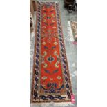 Turkish style red ground runner with floral and stylised bird pattern and multiple geometric borders
