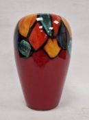 Modern Poole pottery vase, circular and tapering, the red ground with abstract petal border, in