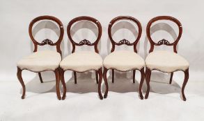 Set of four Victorian balloonback chairs with carved decoration, serpentine front rail to cabriole