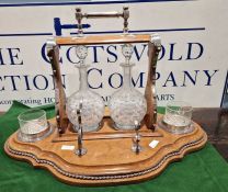 Edwardian oak tantalus, EPNS mounted, with shaped base, two glass decanters and glasses (no key)