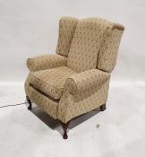Large reclining armchair in pale green foliate upholstery