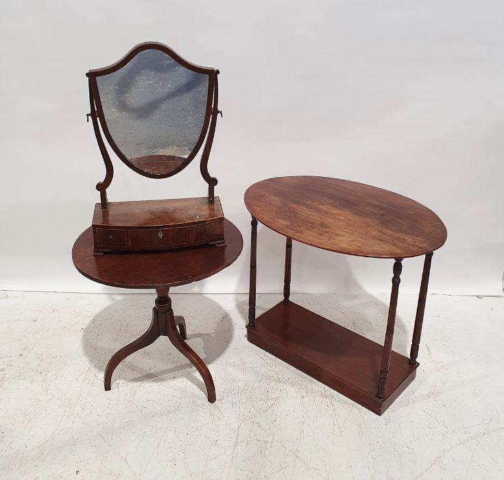 19th century mahogany shield-shaped dressing mirror with three drawers to the bowfront base, on ogee