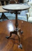 20th century mahogany tripod wine table, the circular top with turned column to three ogee legs,