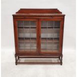 Early 20th century oak bookcase with leaded glazed doors enclosing shelves, on barleytwist