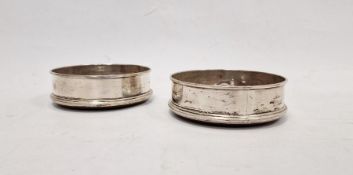 Pair of silver wine coasters, circular and plain with raised border, Sheffield 1970 and turned