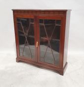 Early 20th century glazed and mahogany bookcase, the rectangular top with moulded edge above