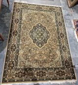 Large modern green ground rug with central floral medallion and multiple floral borders 200cm x