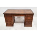 Early 20th century oak pedestal desk with brown leather inset top, nine assorted drawers, on