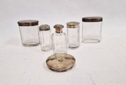 Assorted glass bottles with silver and white metal lids