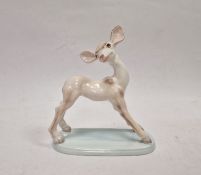Wedgwood & Co early 20th century handpainted pottery fawn, on pale blue oval base, 15.5cm high