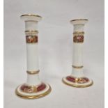 Late 19th century English porcelain pair of candlesticks, each with gilt borders, rose and floral