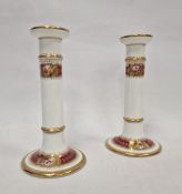 Late 19th century English porcelain pair of candlesticks, each with gilt borders, rose and floral