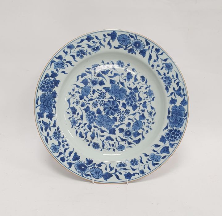 18th/19th century Chinese porcelain charger with underglaze blue decoration of scrolling foliage,