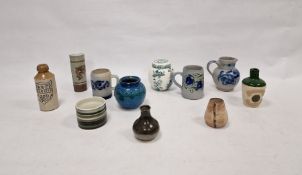 Three German stoneware items, a Cinqueport pottery cylindrical vase (damaged), a small Prinknash